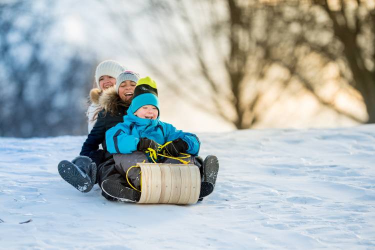 kids sledding down hill